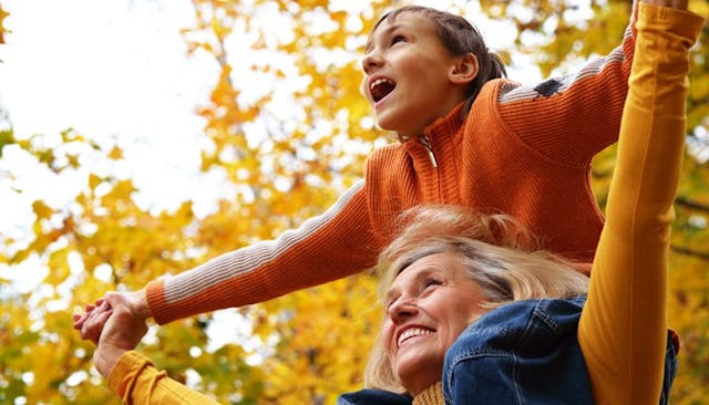 A girl having fun on her mother's shoulders and arms