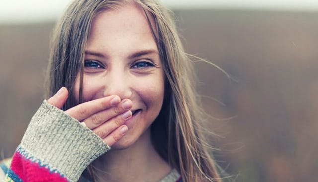 A teenage daughter smiling 