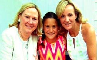 Grandmother, mother, and daughter posing for a photo