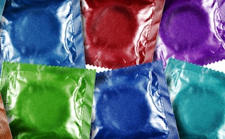 Condoms packed in blue, red, purple and green packages