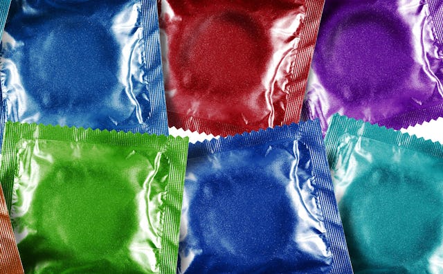 Condoms packed in blue, red, purple and green packages