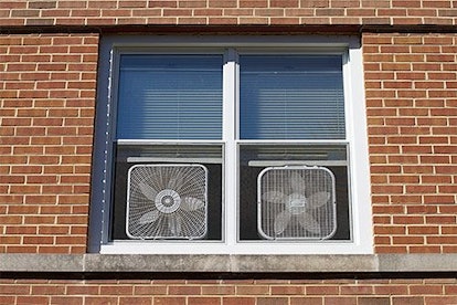 Two windows open with window fans placed on them