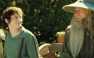 An image of Frodo Baggins and Gandalf smiling at each other.