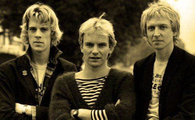 Sting, Stewart Copeland, and Andy Summers from the band The Police posing together