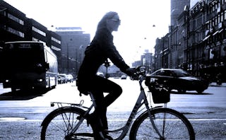 A divorced woman riding a bicycle on an empty street during Father's Day after her dad is gone