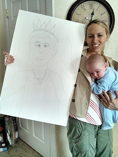 A woman holding her baby and also holding a drawing of a girl wearing a tiara and necklace