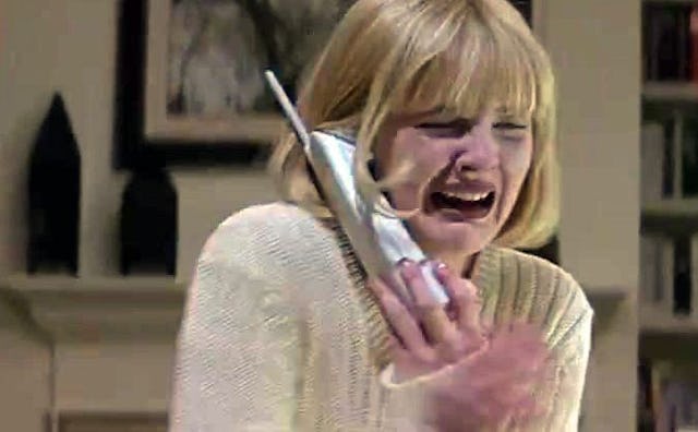 Drew Barrymore as Casey in the movie 'Scream'(1996) crying while holding a telephone