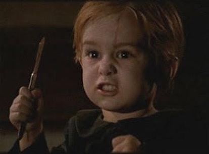  An angry toddler from Pet Sematary holding a stick.