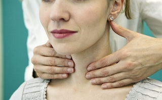 A young lady during a neck massage wants to keep an eye on her neck