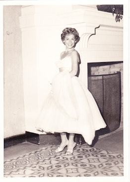 A woman from the 60s, wearing a long white dress