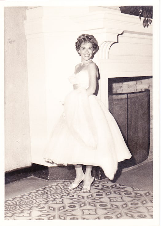 A woman from the 60s, wearing a long white dress