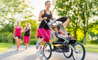 Mother jogging with her toddler in stroller