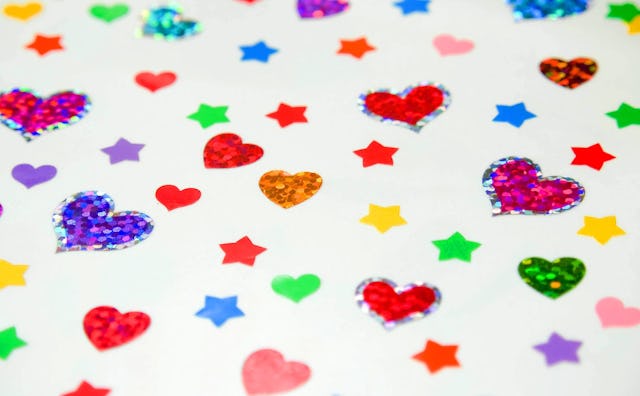 Sparkling hearts and stars stickers in various colors on a white background