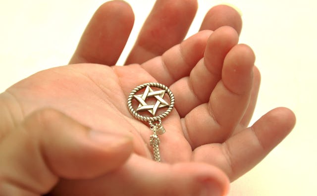 David's star necklace in a Jewish girl's palm.