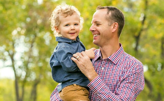 A father over the age of 40 holding his son