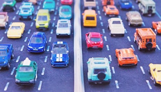Toy cars placed into lanes representing daily commuting 