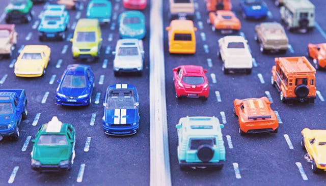 Toy cars placed into lanes representing daily commuting