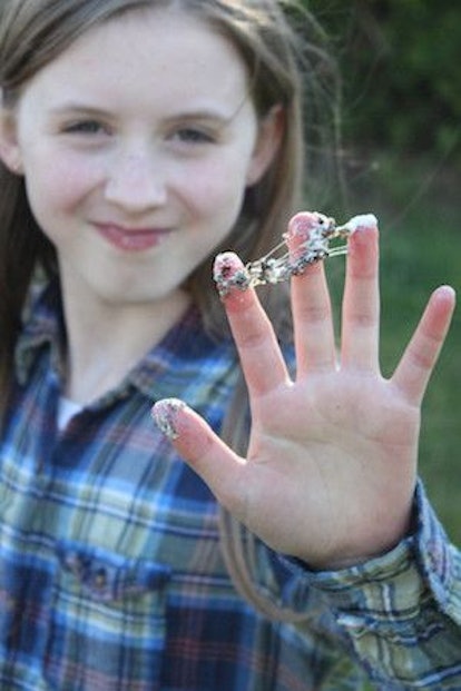 A girl with tree sap on her fingers 