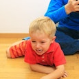 Little boy laying on the floor crying