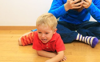 Little boy laying on the floor crying