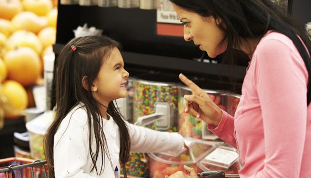 An entitled brat wanting something and shouting at mother for not getting her candy and mom trying t...