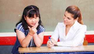 A girl improving her math skills with her teacher