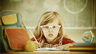 Little kid sitting in school dressed in the 70s style 