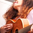 happy-woman-playing-guitar