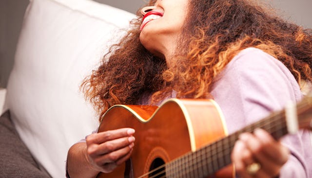 happy-woman-playing-guitar