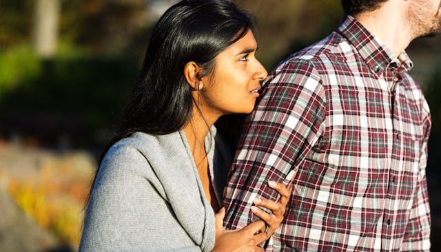 A woman longing after her husband who doesn’t want to have sex with her, holding onto his arm as he'...