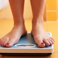 A person standing on the weight scale.
