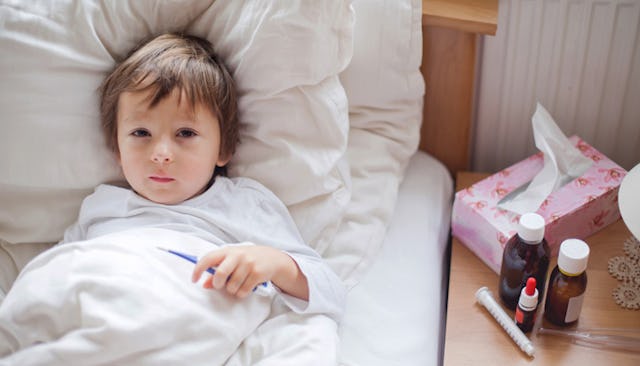 A brown-haired child with sepsis lying in a hospital bed