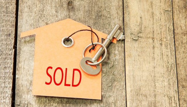 Key with a keychain that says "sold" on it.