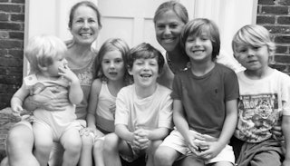 Two mothers who share 38 years of friendship and five children sitting on a porch in black and white