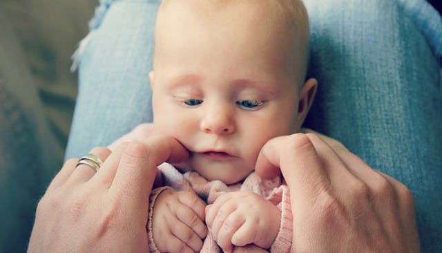 A woman holding her baby in her lap