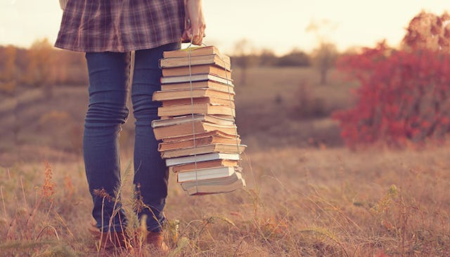 woman-carrying-bundle-of-books