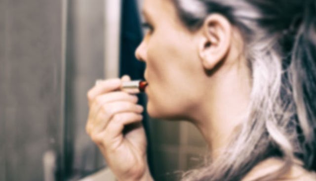 woman-with-gray-hair-applying-makeup