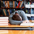 student-sleeping-in-library