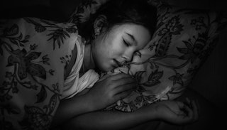 A young girl co-sleeping in a black and white photo