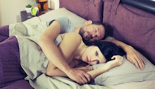 unhappy-woman-in-bed-with-sleeping-husband