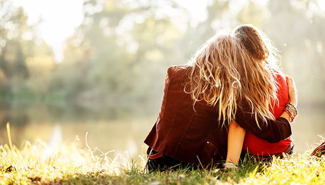 mother-daughter-sitting-hugging