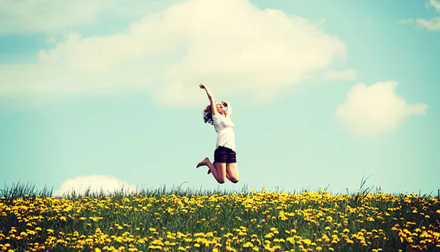 young-woman-jumping-in-flower-meadow