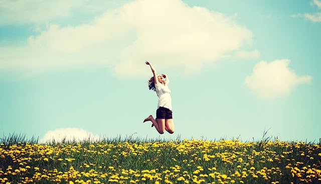 young-woman-jumping-in-flower-meadow