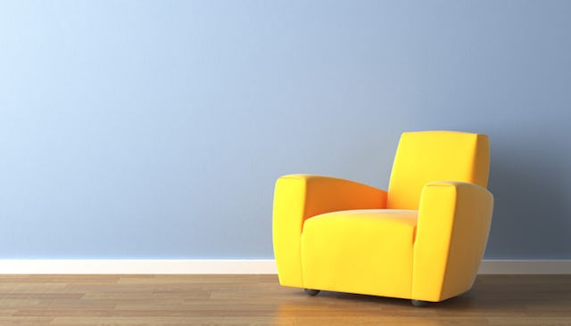 A big yellow armchair in a room.