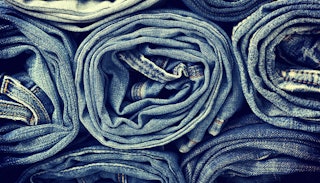 A stack of rolled-up blue denim mom jeans
