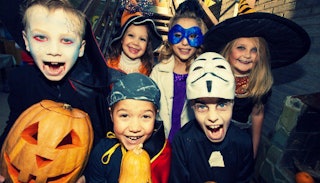 Six kids in their '80s Halloween costumes all looking scary