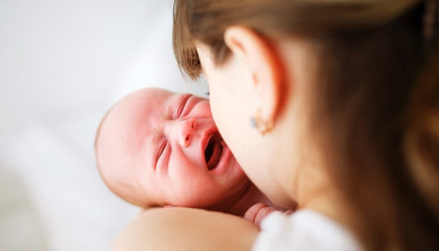 Mother holding and nursing a reflux baby