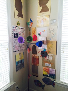A scotch-taped corner with a child's drawings and their craft projects.