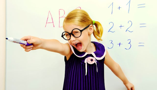 A furious little girl screaming and pointing with her pen at something with a whiteboard behind her ...