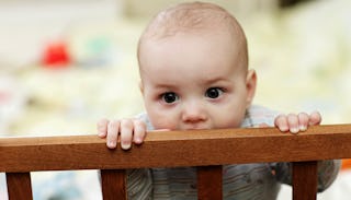 Baby standing in a bed 